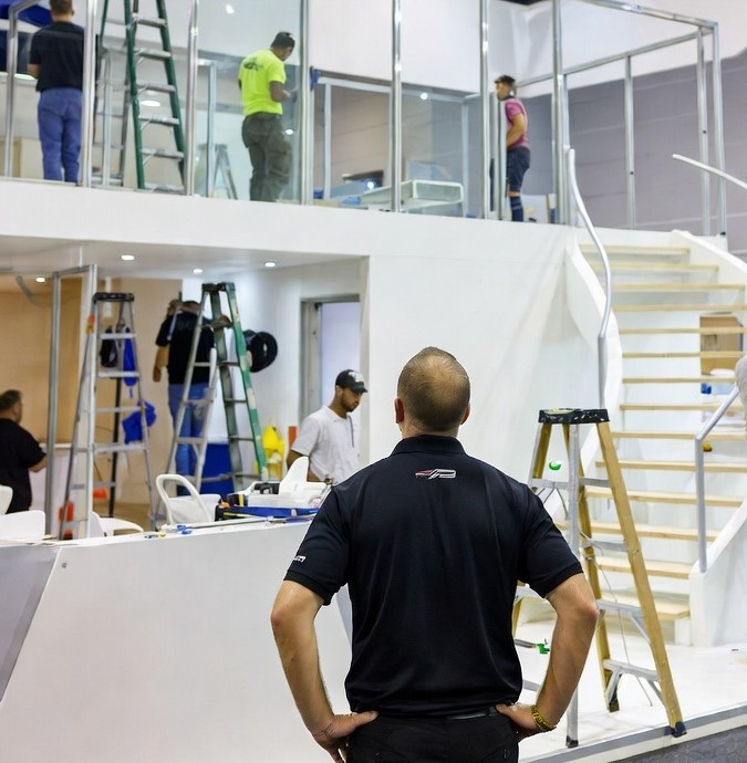Install crew assembling structural exhibit framework on the show floor